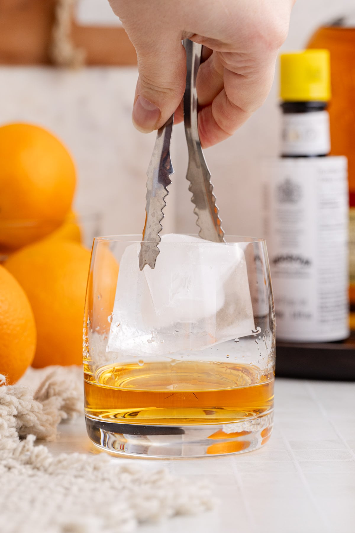 Ice cube being added to glass