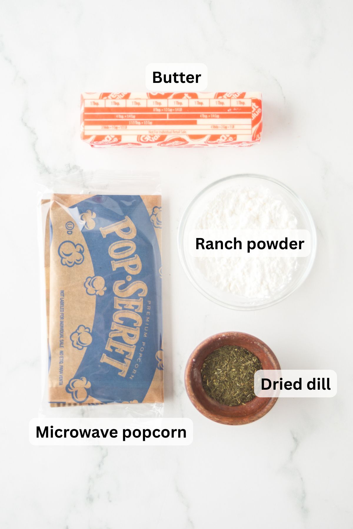 All the ingredients needed to make Ranch Popcorn on a table.