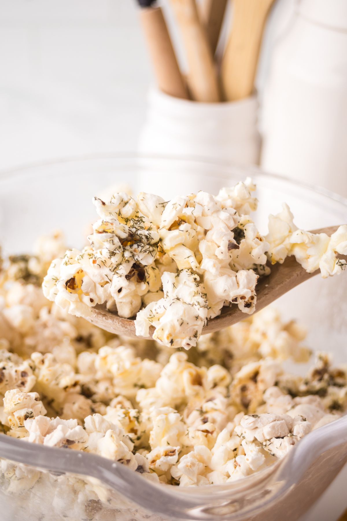 A spoonful of popcorn held in the air.