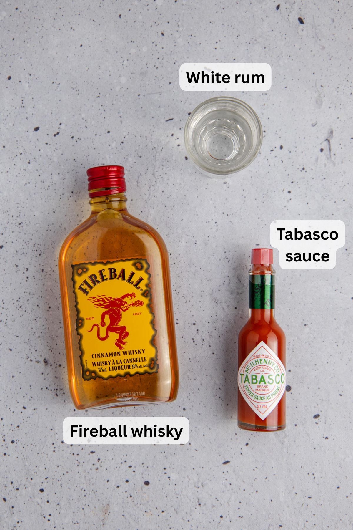 All of the ingredients needed to make a Fireball shot on a table.