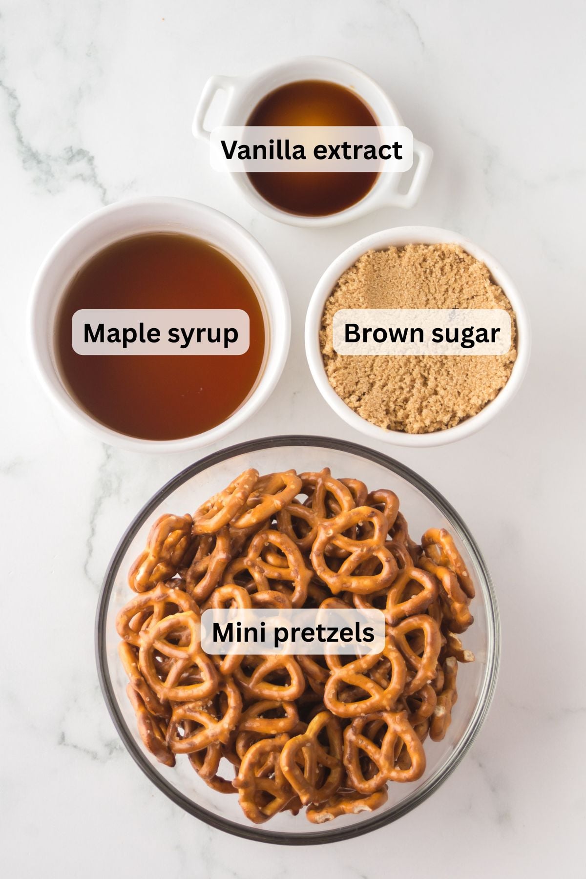 All of the ingredients needed to make maple pretzels in bowls on a table.