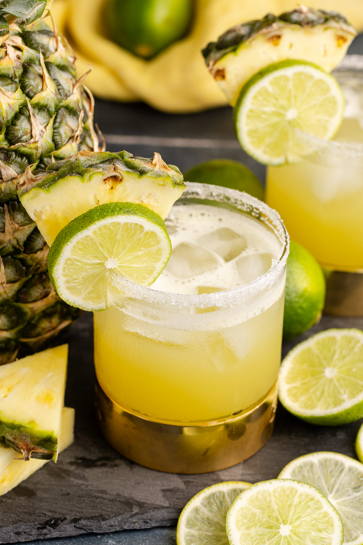 A glass filled with pineapple margarita.