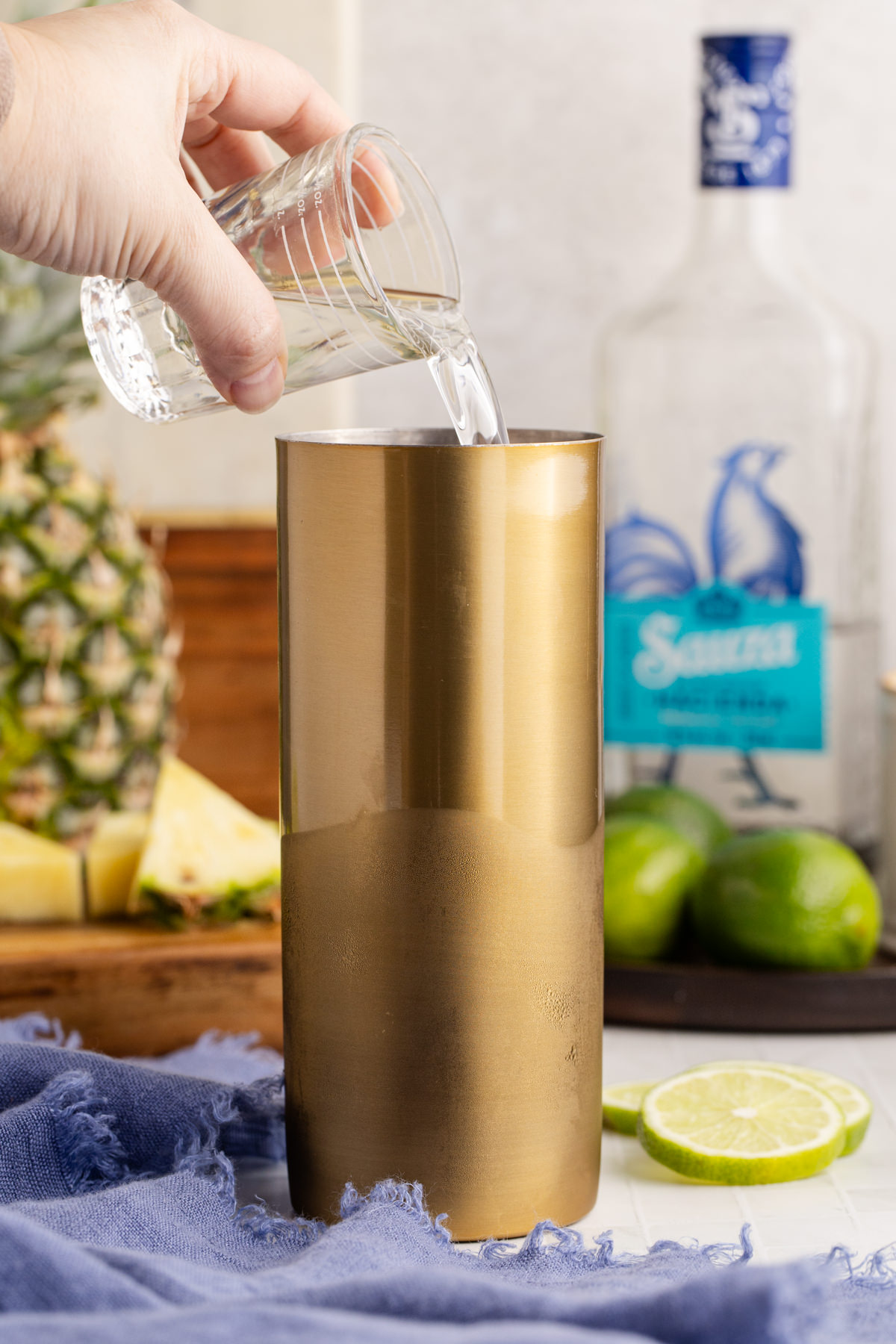 Ice and the tequila added to the cocktail shaker.