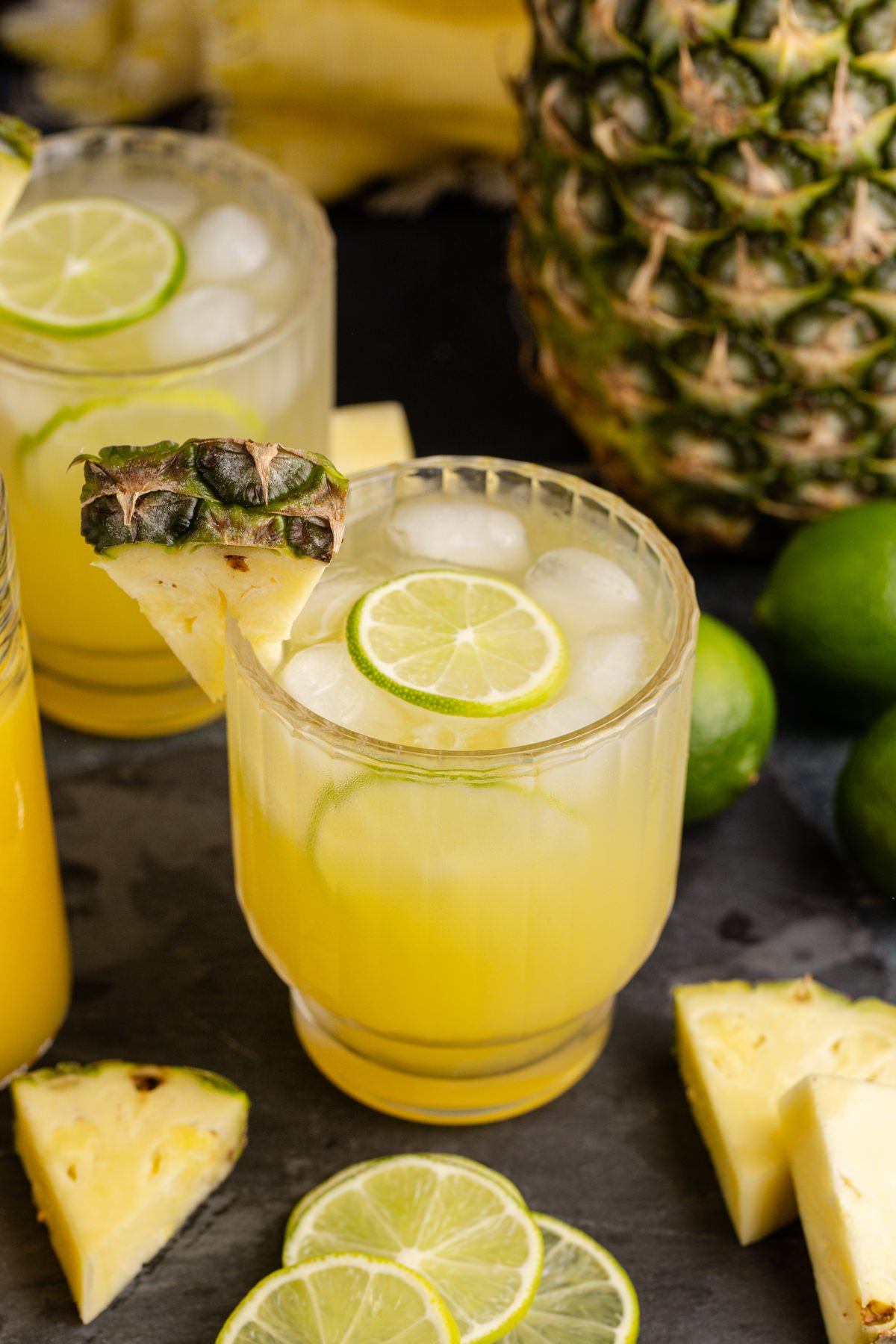 A pineapple cocktail with a lime inside.