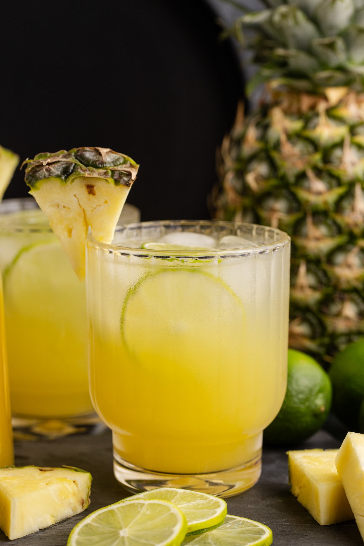A wedge of pineapple added and a garnish to finish the cocktail.