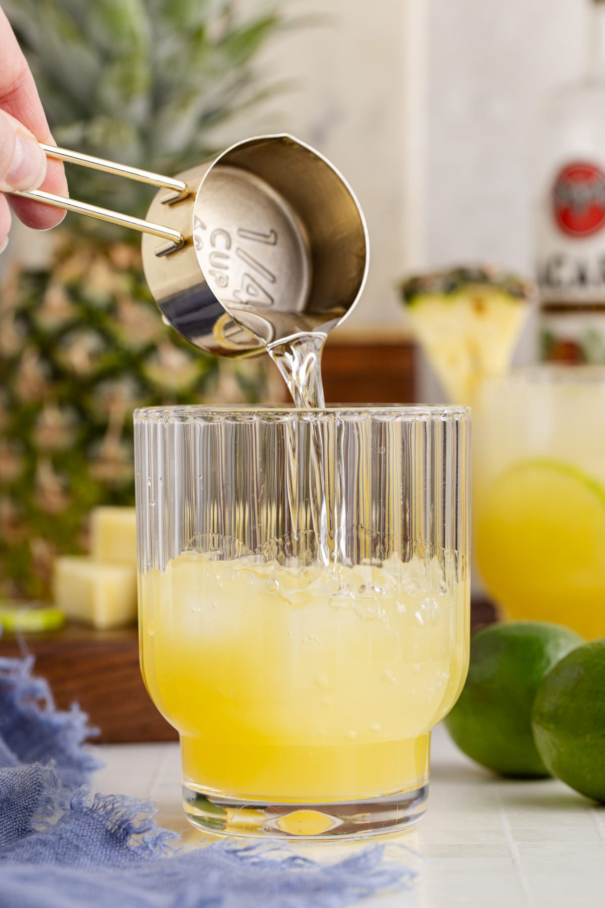 Ice, rum and juices poured into a glass.