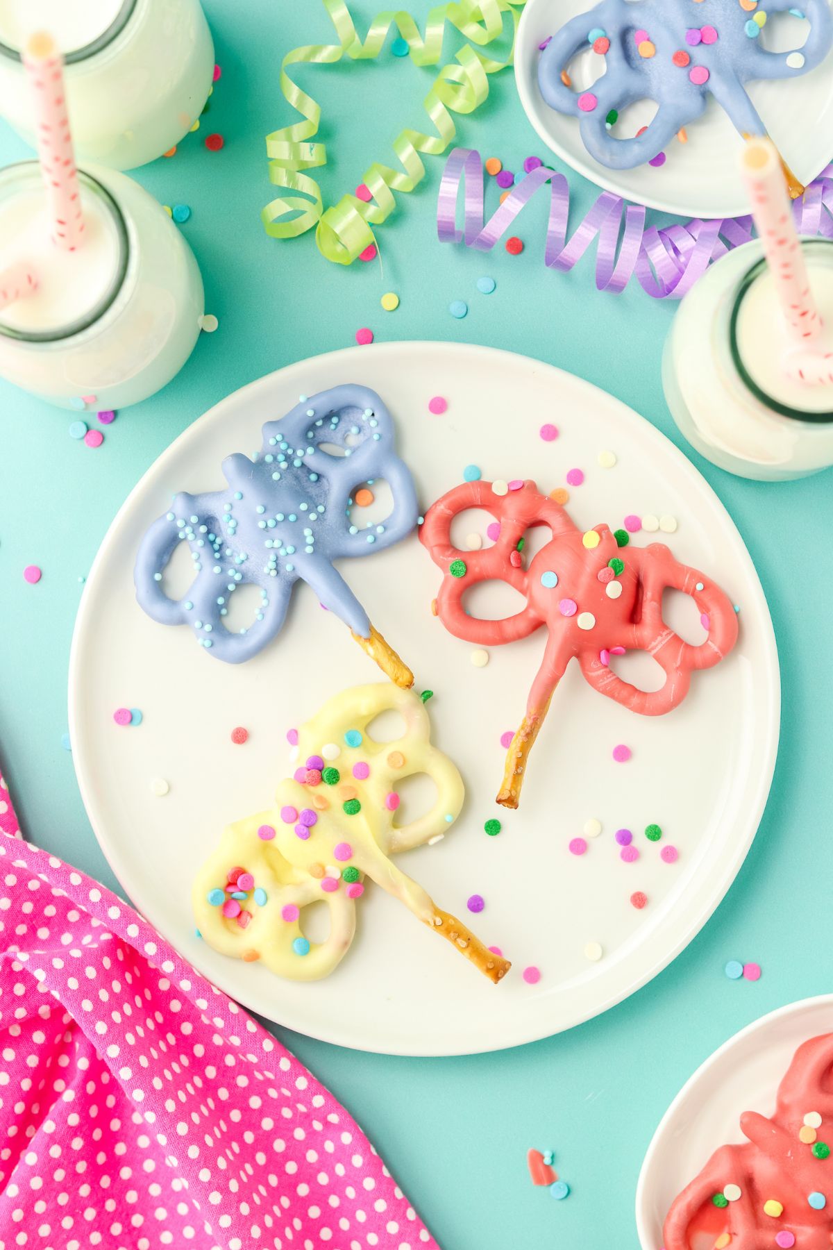 Pretzels dipped in candy melts in the shape of butterflies.