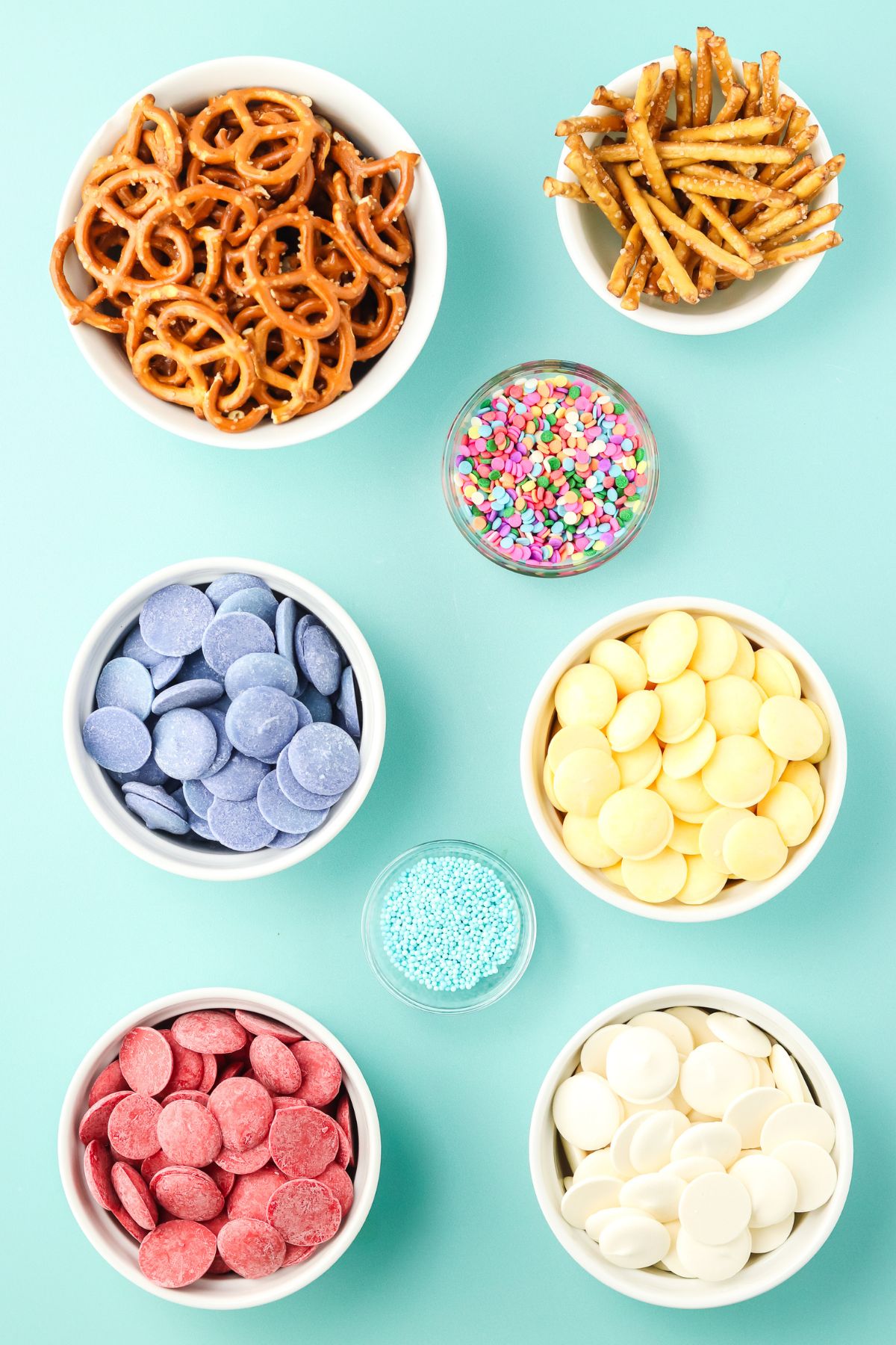Ingredients for butterfly pretzels in bowls on a table.