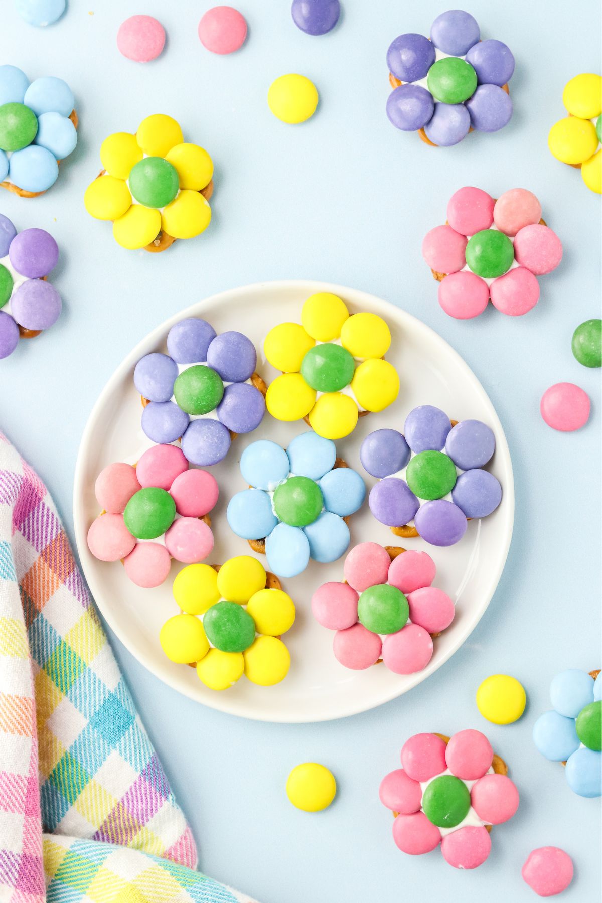 Seven flower pretzels on a white plate. 