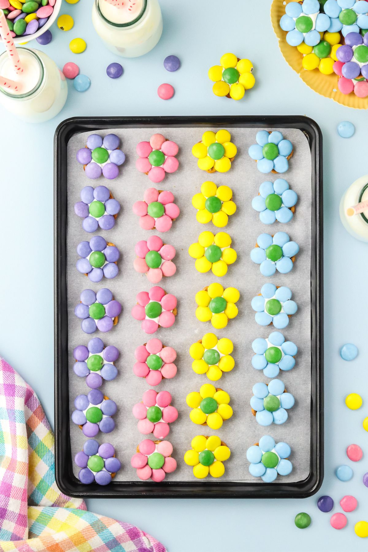 All of the completed flower pretzles on a baking sheet.