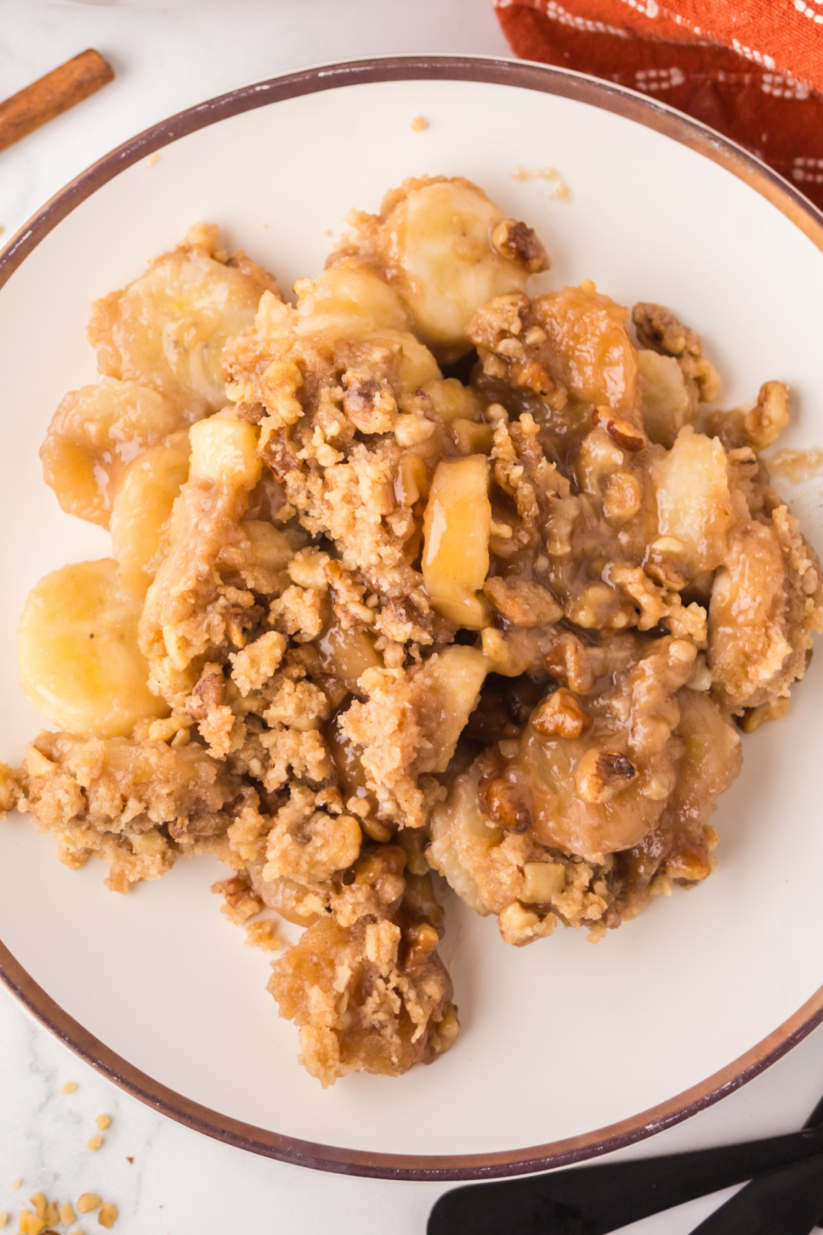 A helping of cobbler with bananas on a plate.