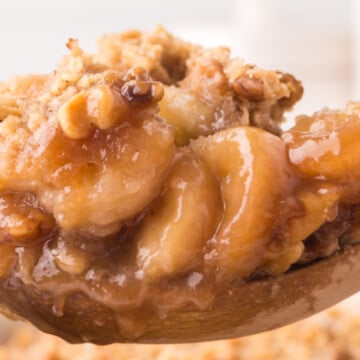 A wooden spoon full of banana cobbler.