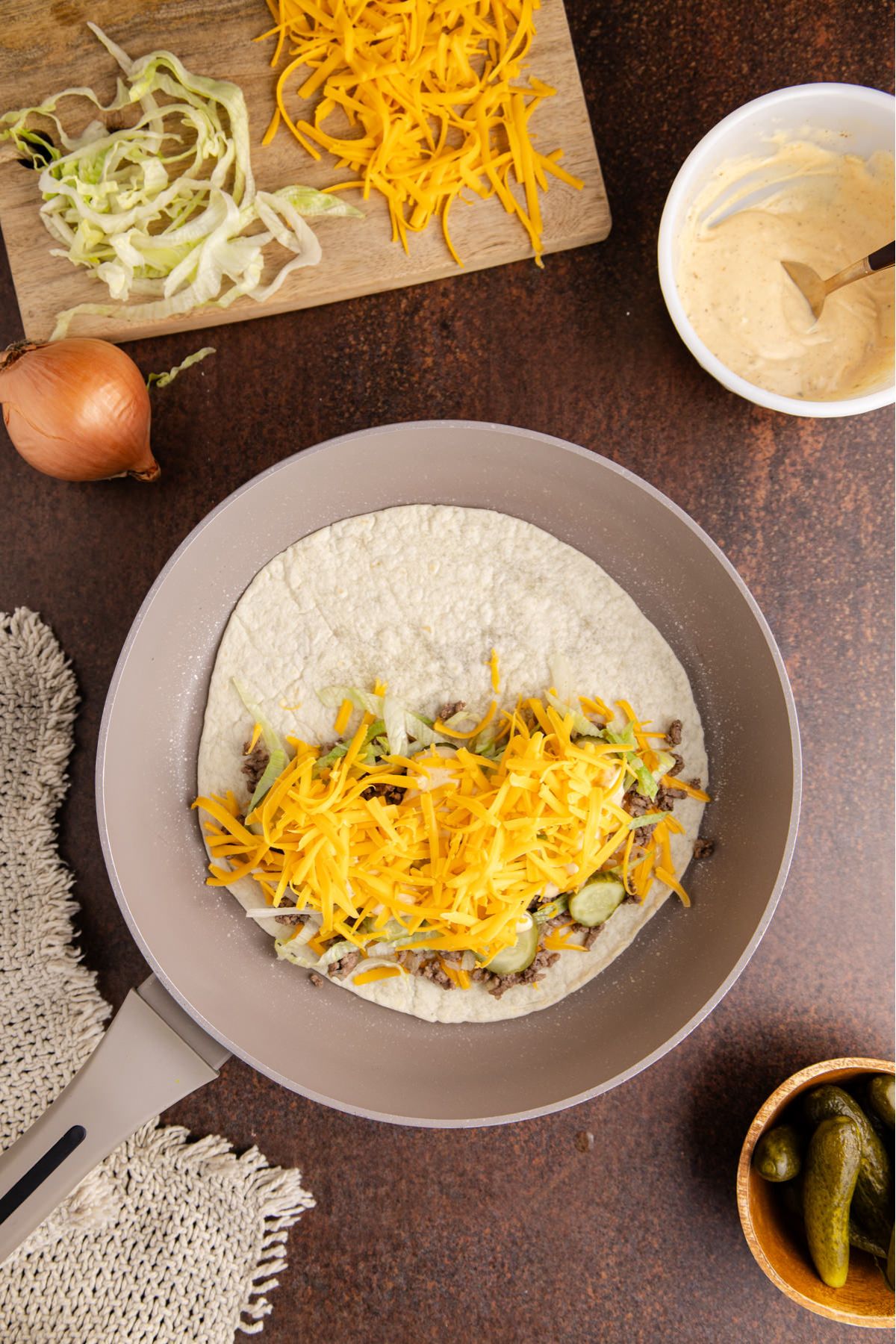 Shredded cheese added to the top of the quesadilla.