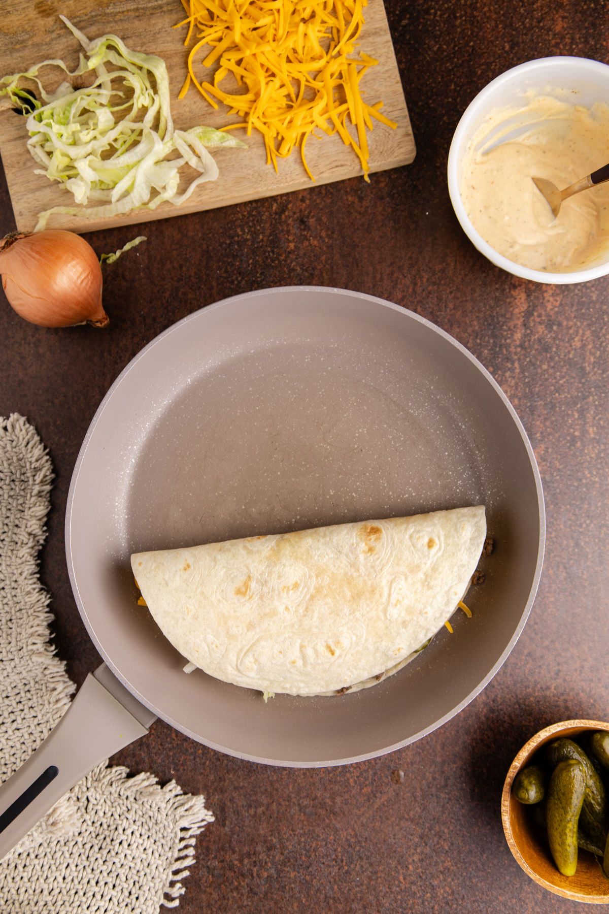 Tortilla cooking for a few minutes until the tortilla is golden brown.