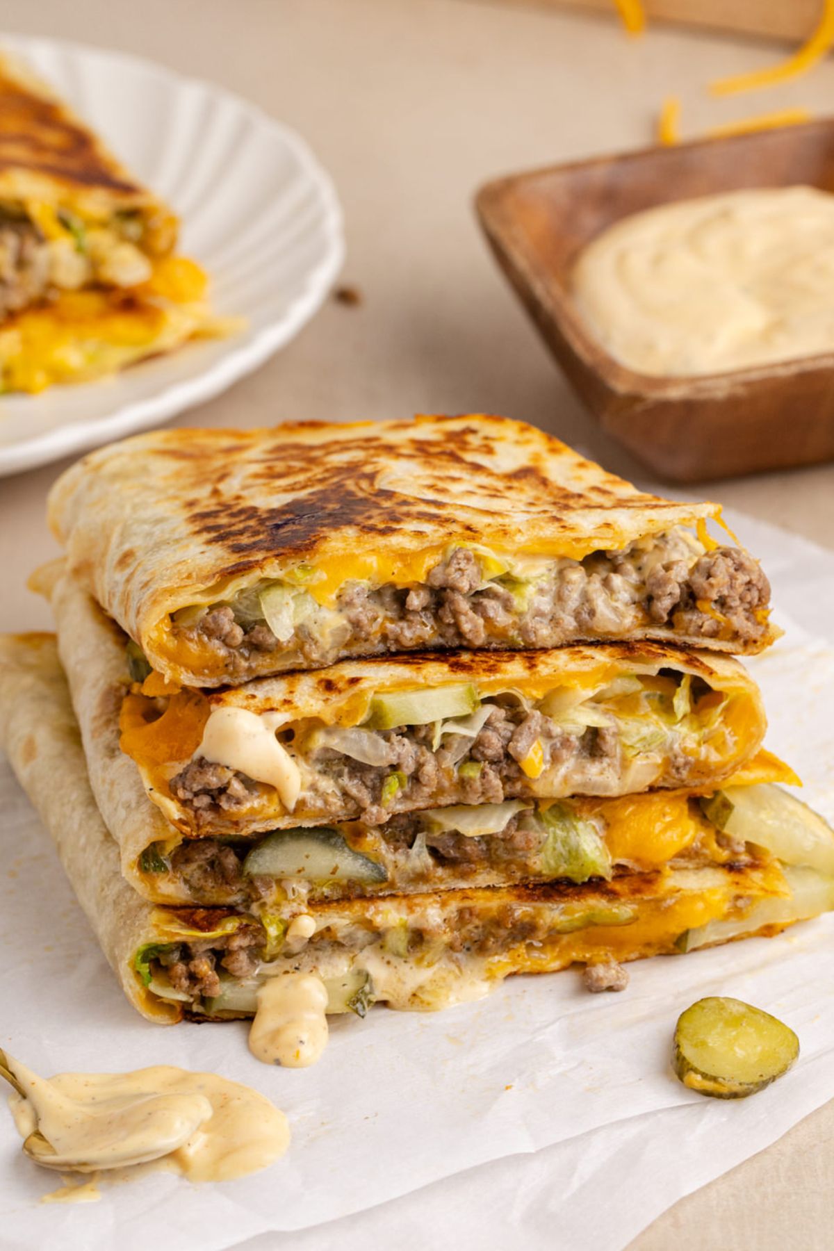 Quesadillas cut in half with beef, cheese and sauce.
