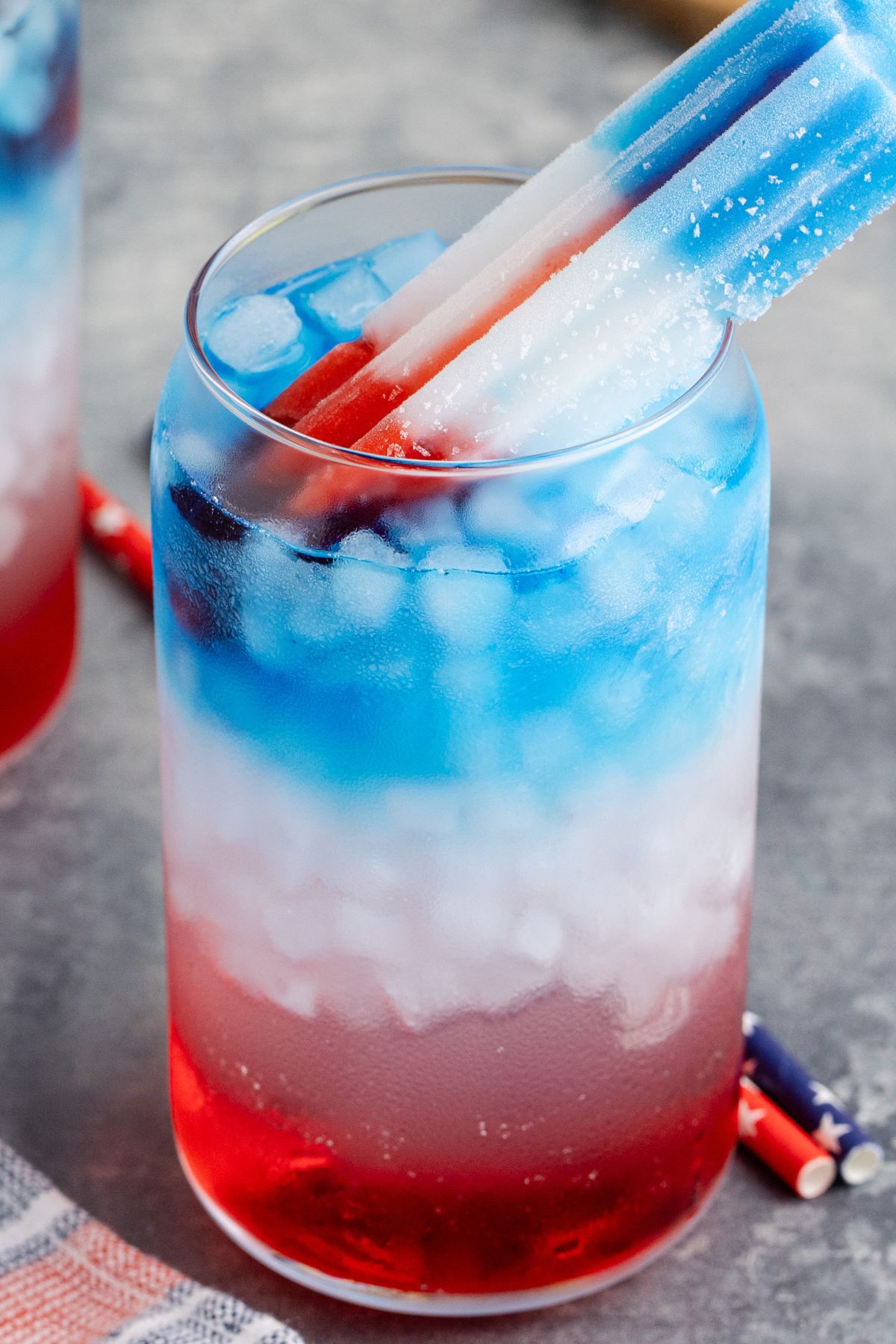 A popsicle sticking out of the drink.