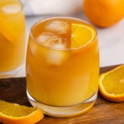 A glass of Brass Monkey with a orange wedge garnish,