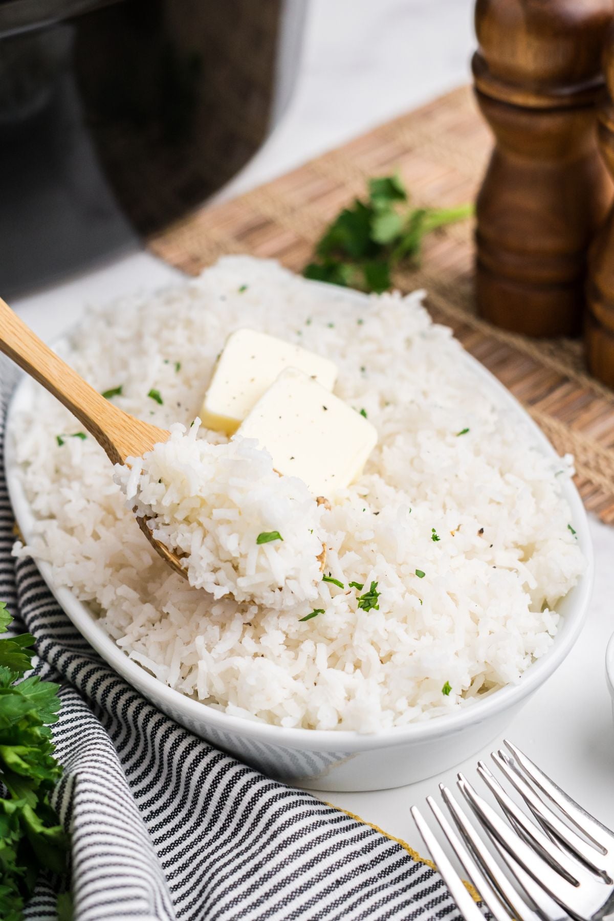 A spoon taking some slow cooker rice out of the bowl.