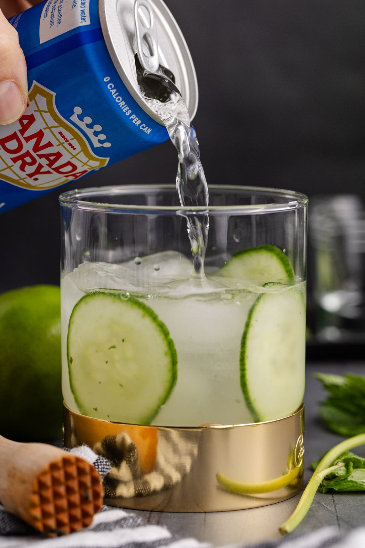 cocktail being topped with club soda