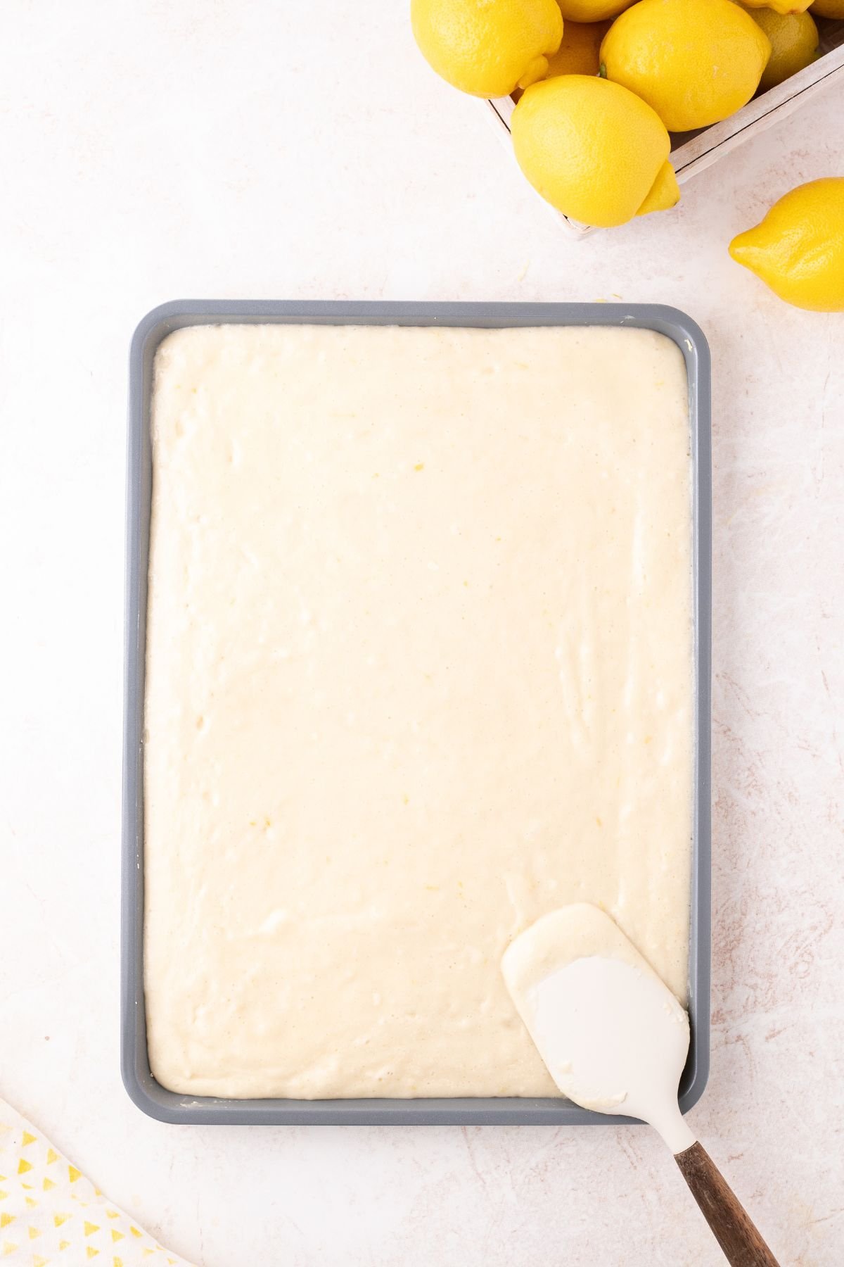 Cake batter transfered to a baking pan.