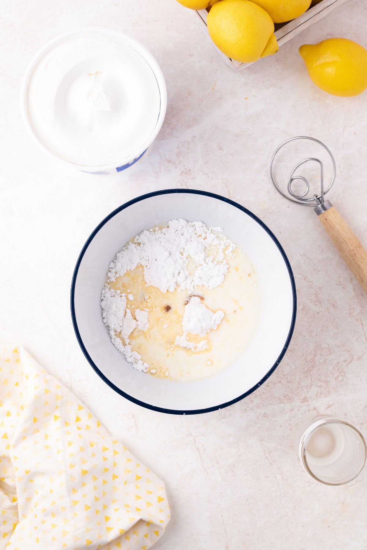 Pudding mix, powdered sugar, milk, and vanilla combined in a bowl.