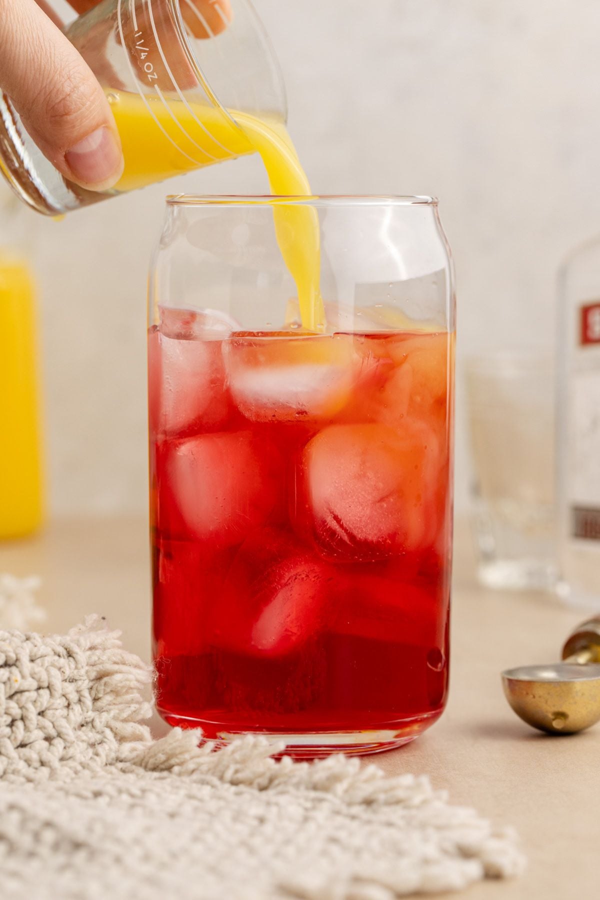 orange juice being added to drink