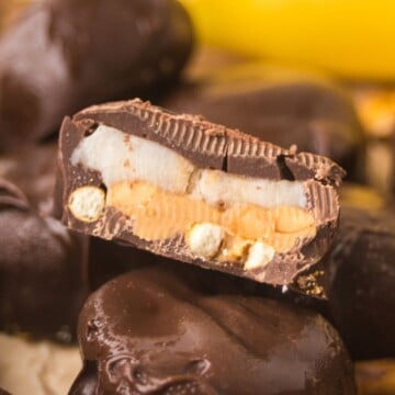 A pile of pretzel chocolate peanut butter banana bites, with one cut in half.
