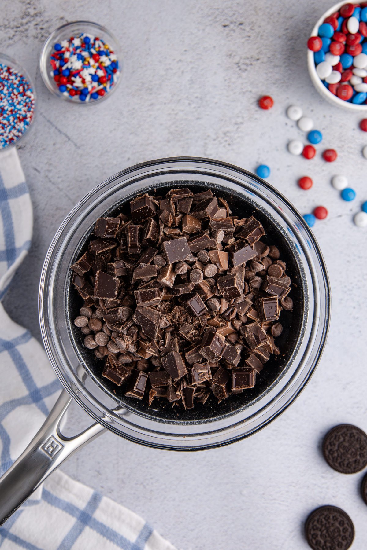 A heat-safe bowl over a saucepan with semi-sweet and milk chocolate.