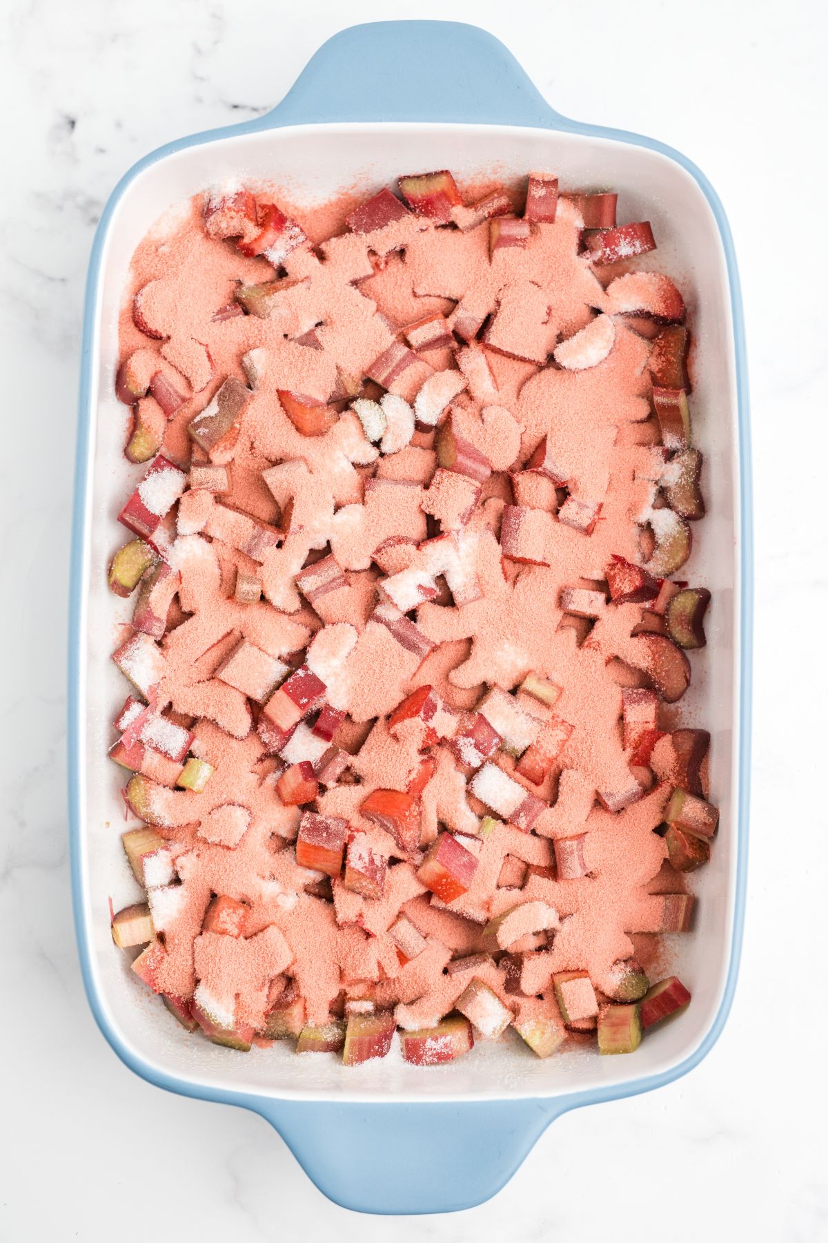 White sugar and strawberry Jello mix over the top of the rhubarb.