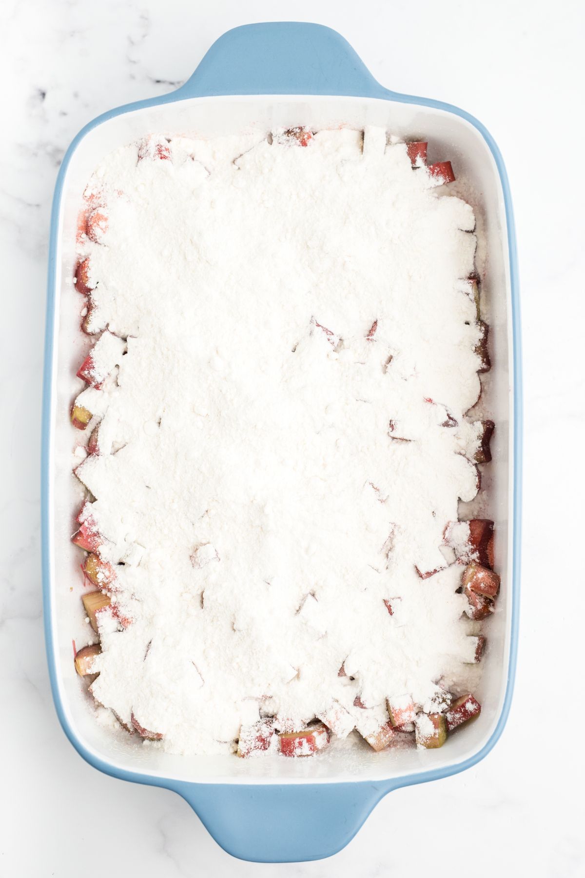 Cake mix sprinkled on top, covering everything below it.