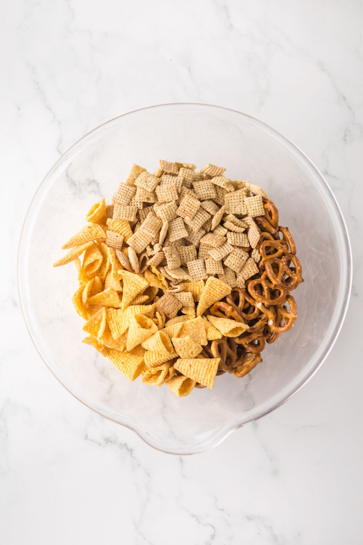 mini pretzels, bugles, and rice chex in a large mixing bowl.