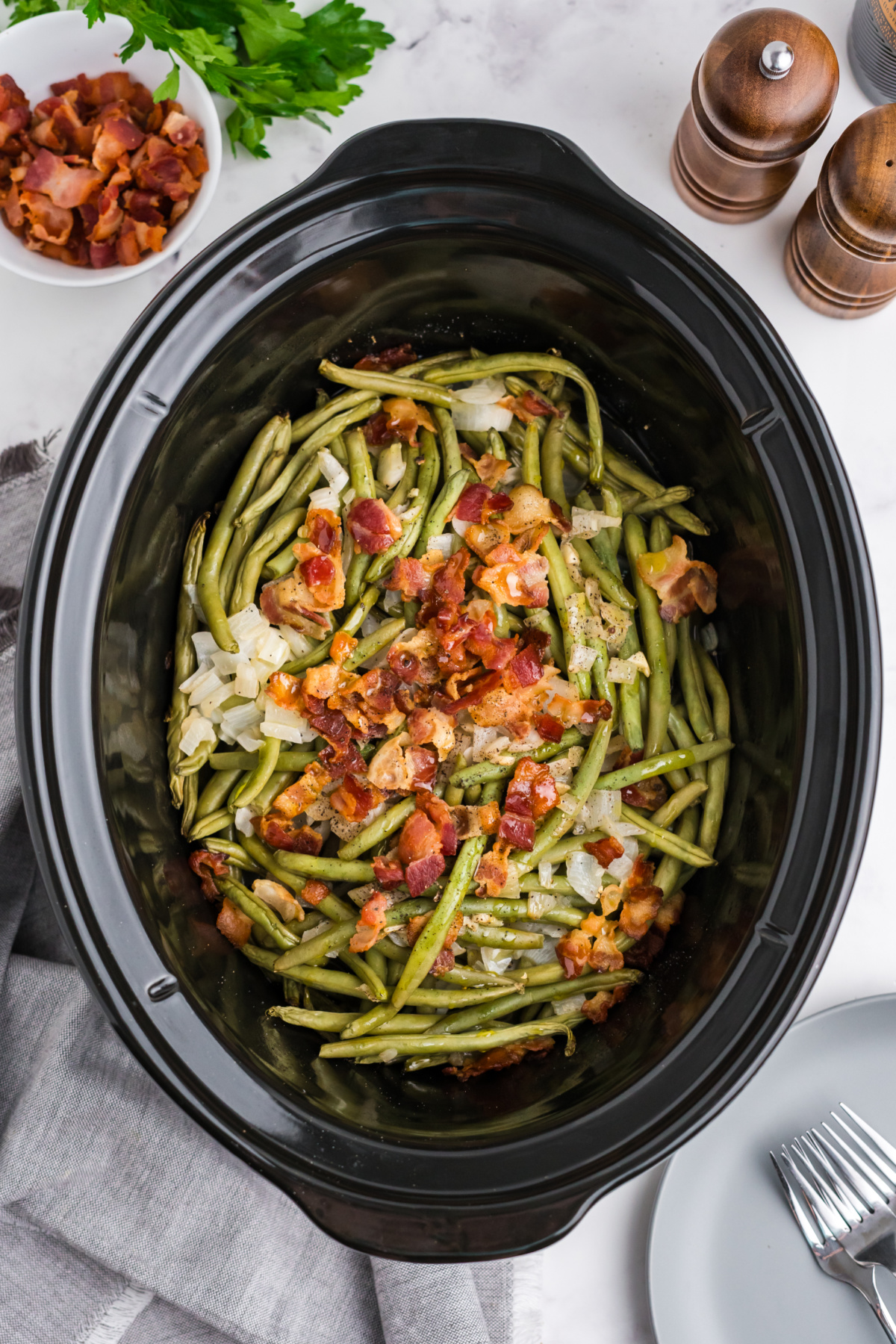 Green beans, bacon, onions, garlic cooked in the crockpot.