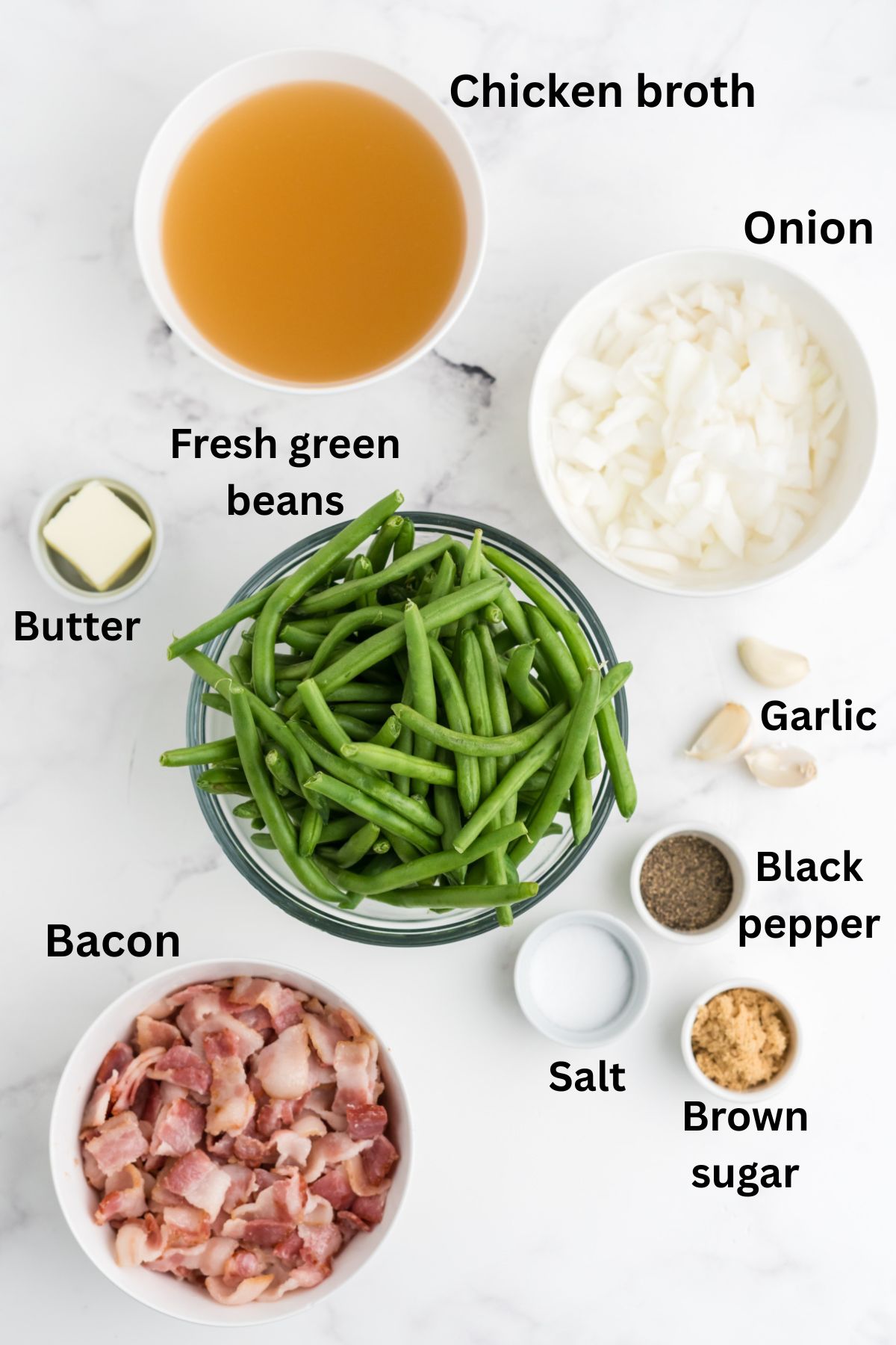 Ingredients for crockpot green beans in bowls on the table.