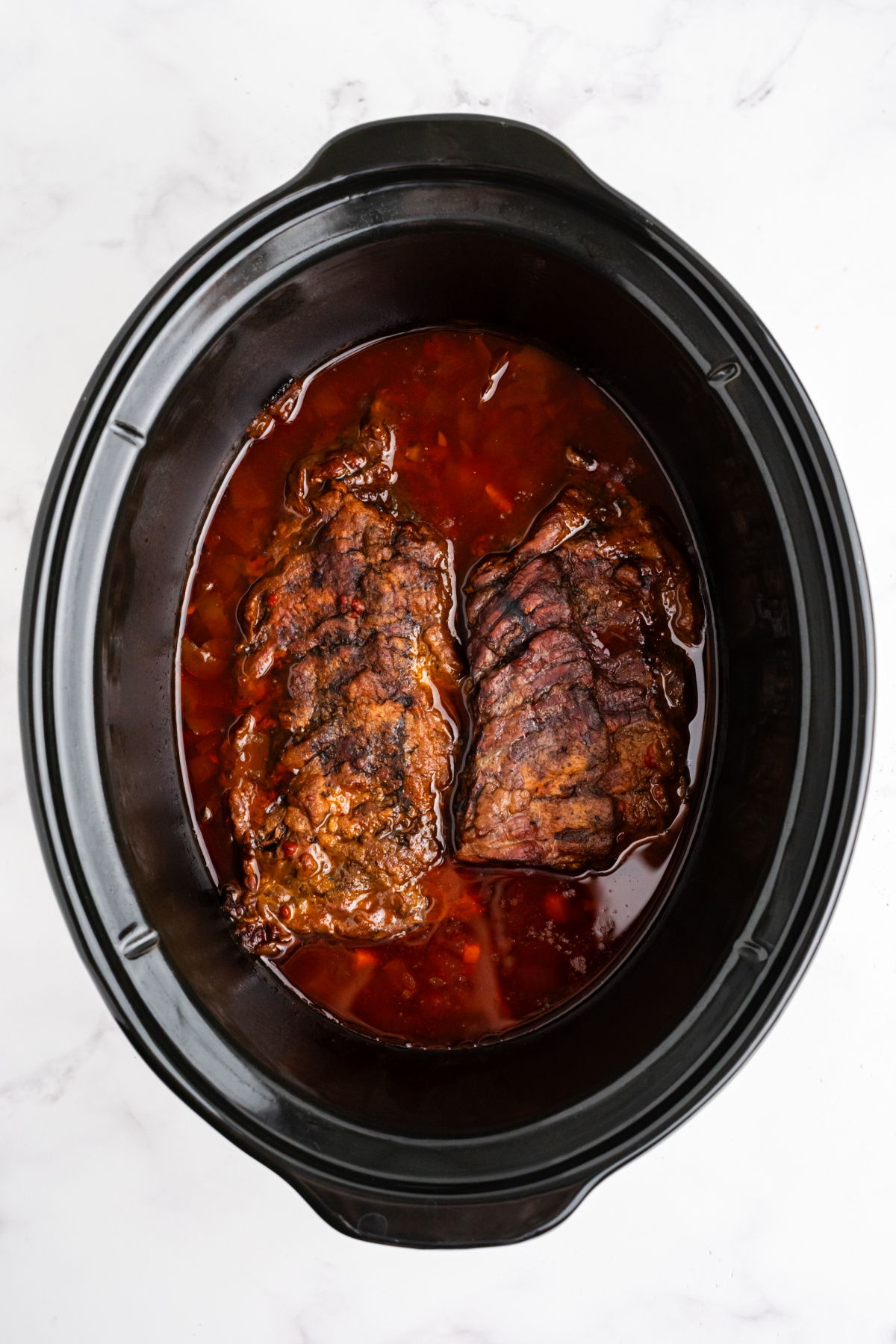 Skirt steak with the onions and sauce cooked in the slow cooker.