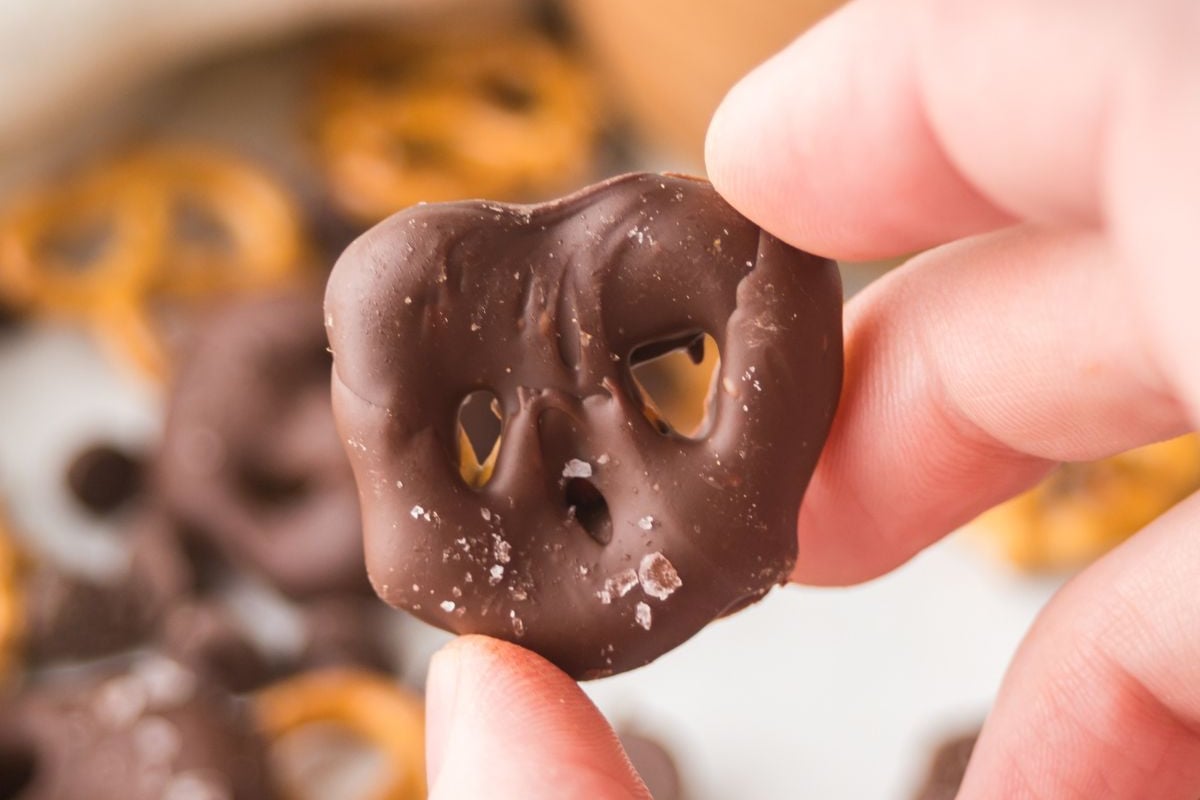 A pretzel held in the air.