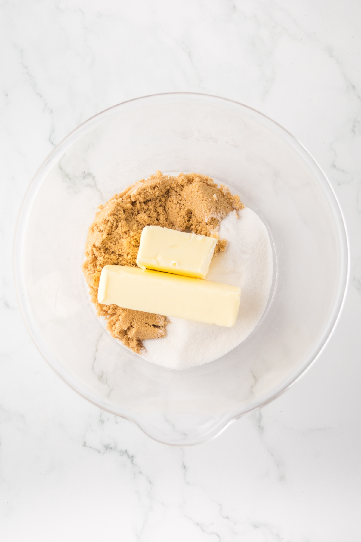 Softened butter, white sugar, and brown sugar in a mixing bowl.