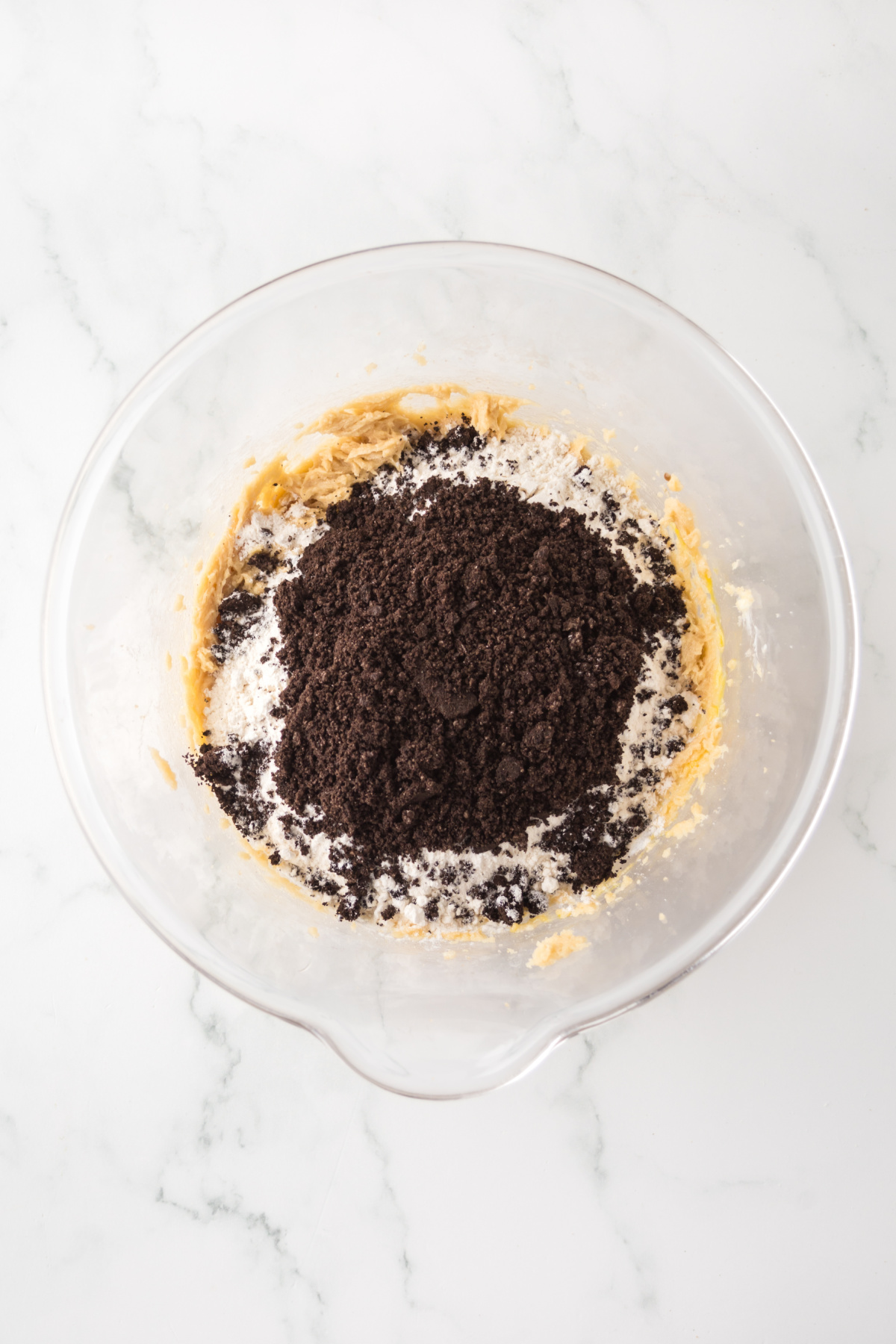 Flour, baking powder, baking soda, and crushed oreos whisked with the wet mixture.