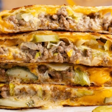 A quesadilla cut in quarters in a pile.