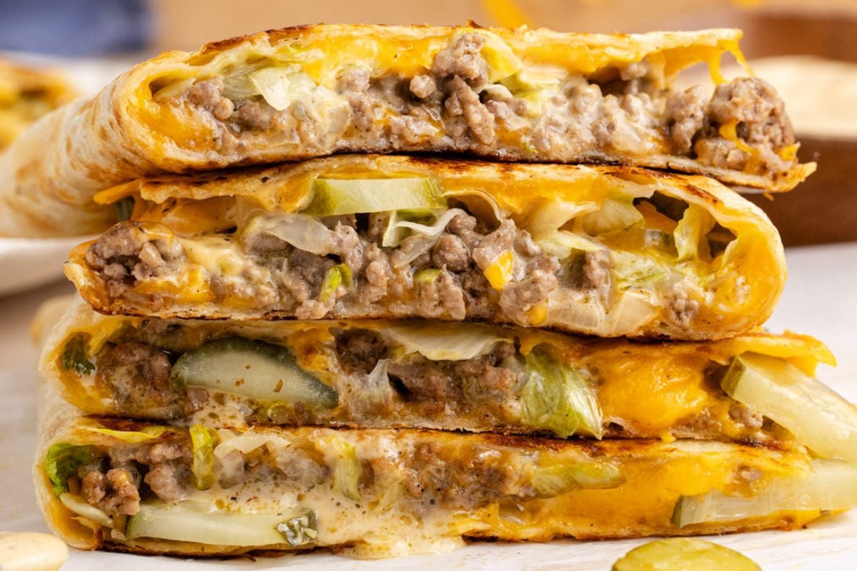 A quesadilla cut in quarters in a pile.