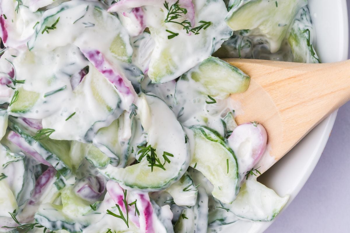 A spoonful of creamy cucumber onion salad.