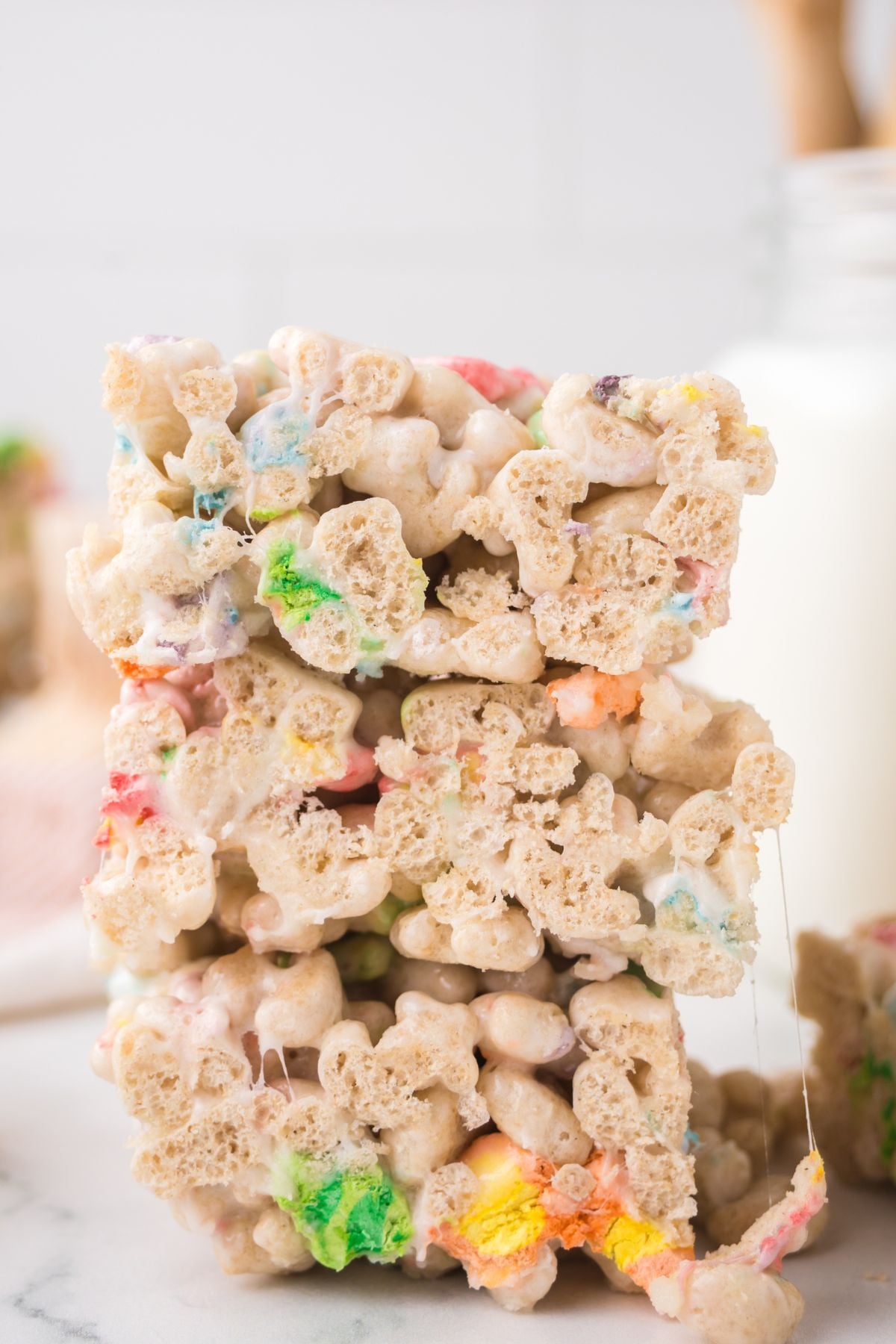 Rice krispie treats with lucky charms stacked on top of one another.