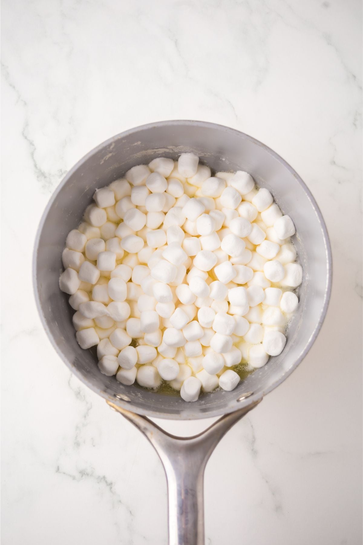 Butter and marshmallows melting in a saucepan.