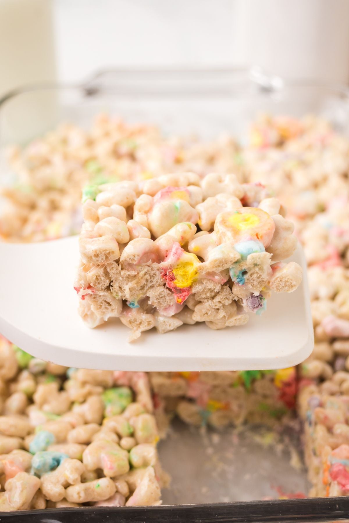 Rice Krispie treats set and a square lifted with a spatula.