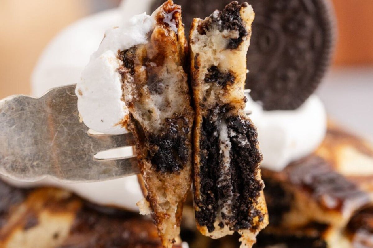 Two slices of pancakes on fork.