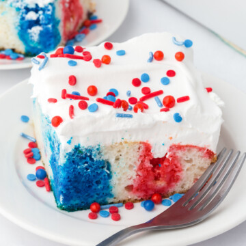 a slice of red white and blue poke cake on a plate