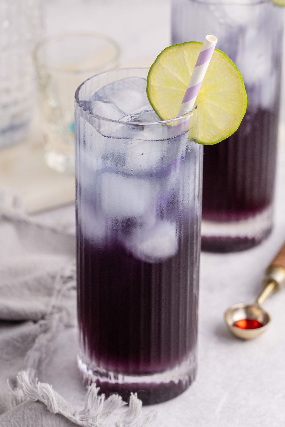 Final drink on table with straw and lime.