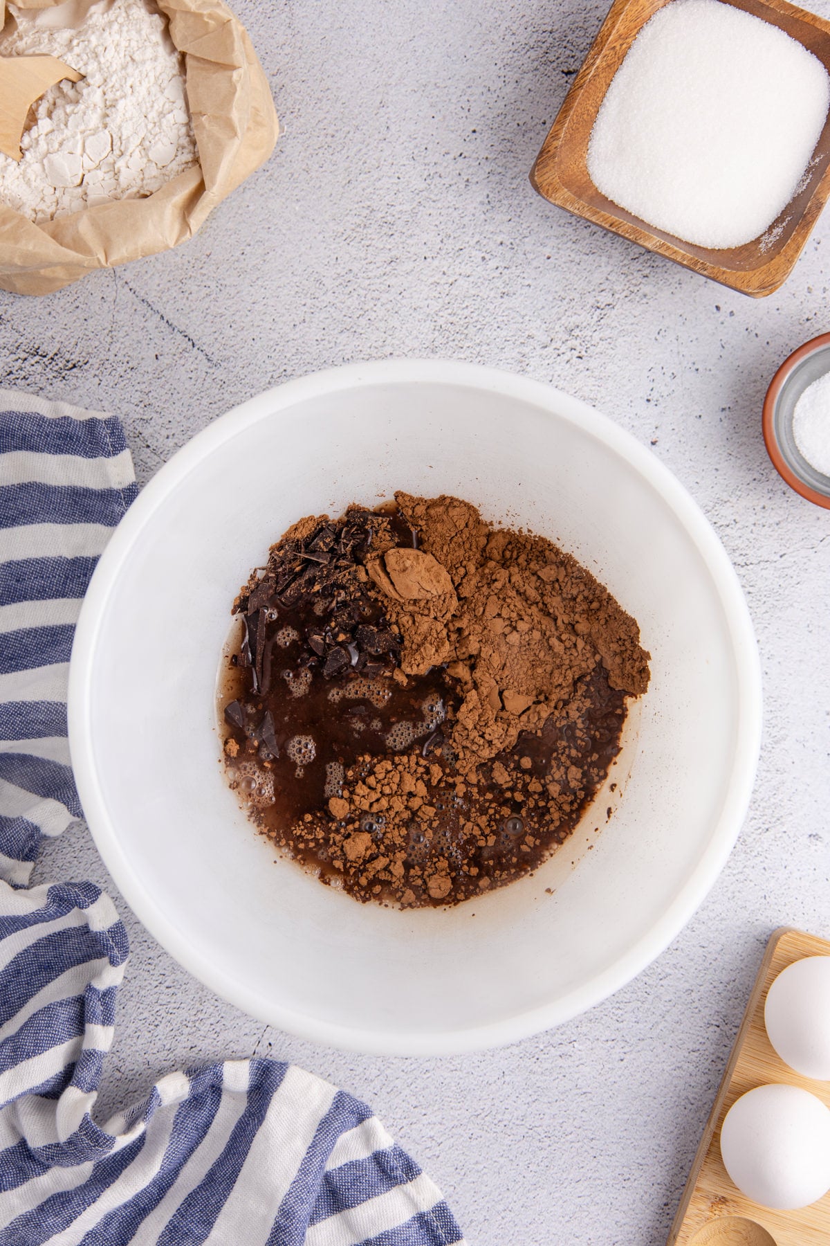 Chocolate, oil, eggs, and vanilla and cocoa powder in a bowl.