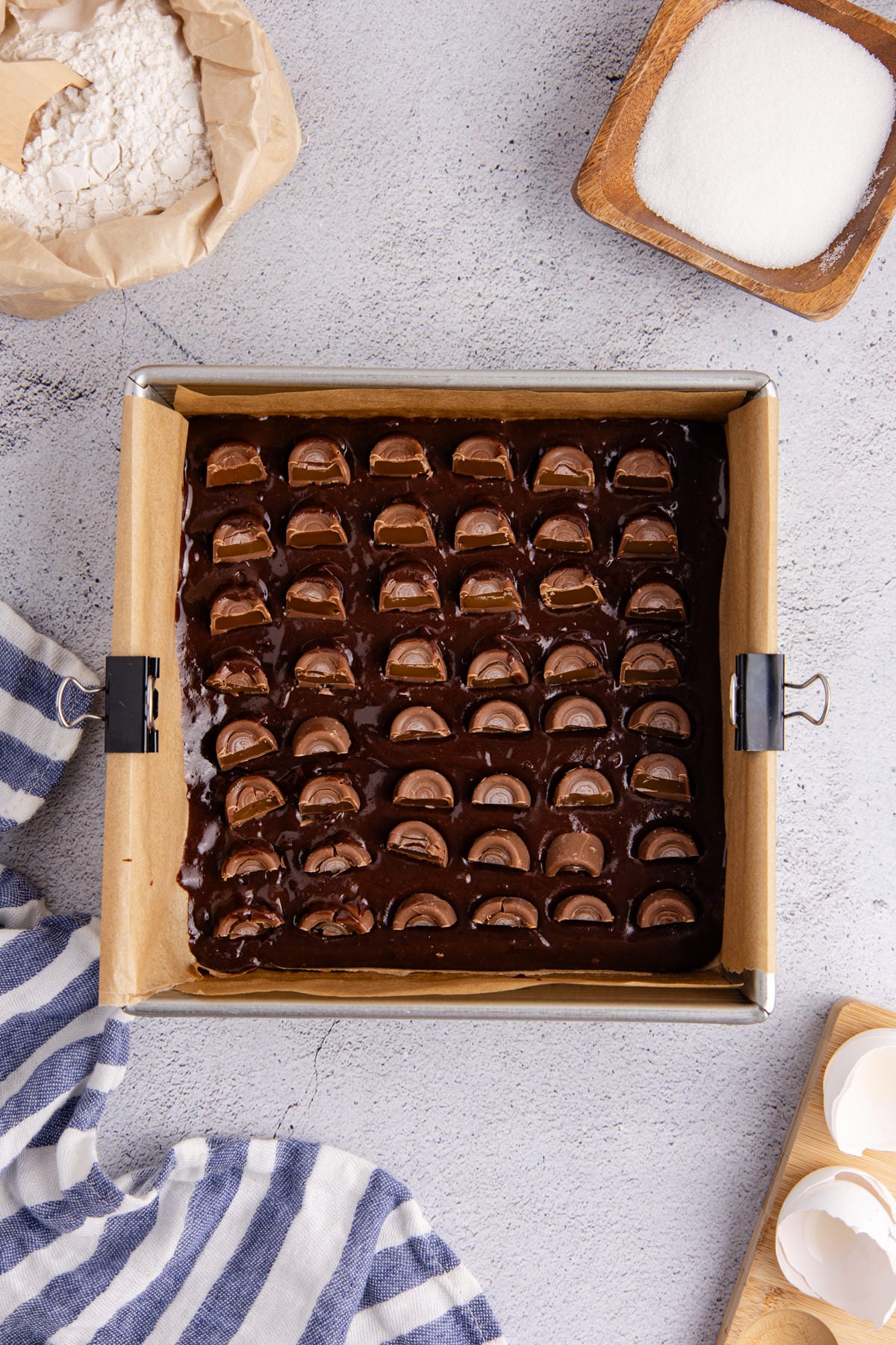 The batter added to a baking pan and a layer of frozen rolos into the batter.