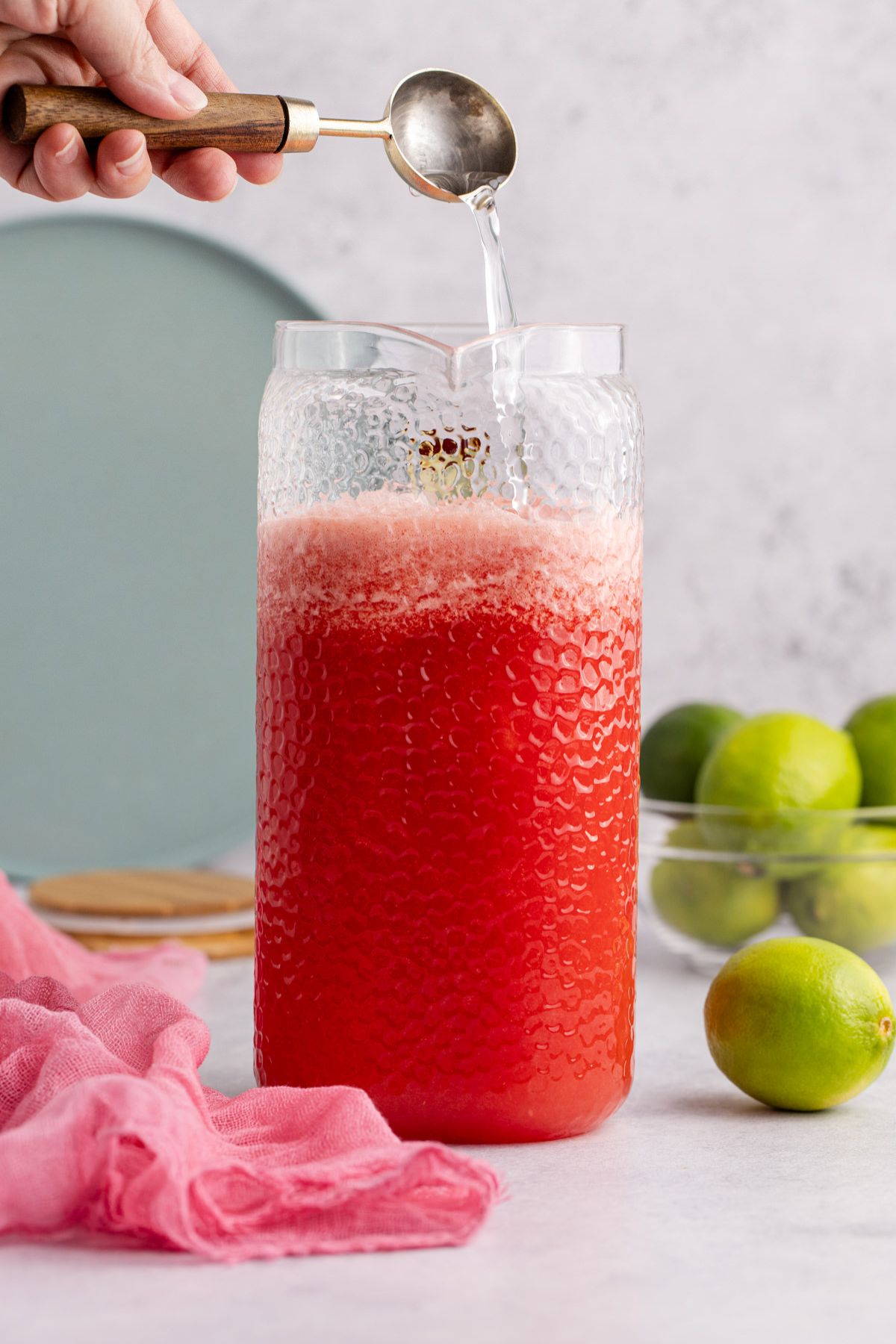 Syrup being added to pitcher.