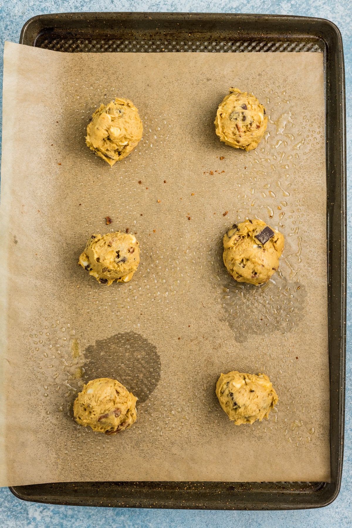 The cookie dough balls arranged on the baking sheet.